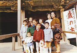 西新井大師で七・五・三の記念写真。前列右端が修二さん、右隣がお母さん（近所のみんなと一緒に）